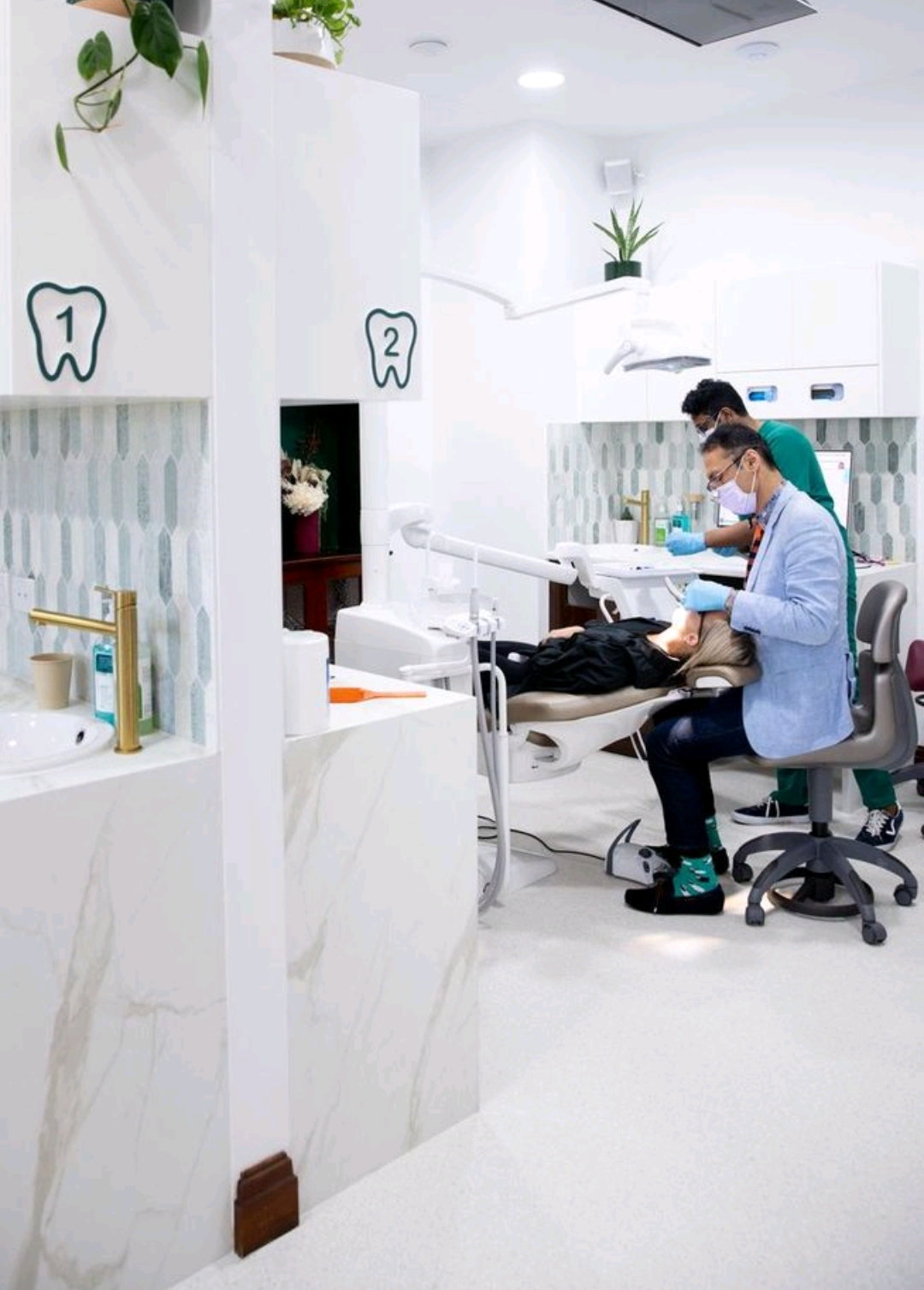 Numbered tooth wayfinding above treatment bays one and two at Wired Orthodontics